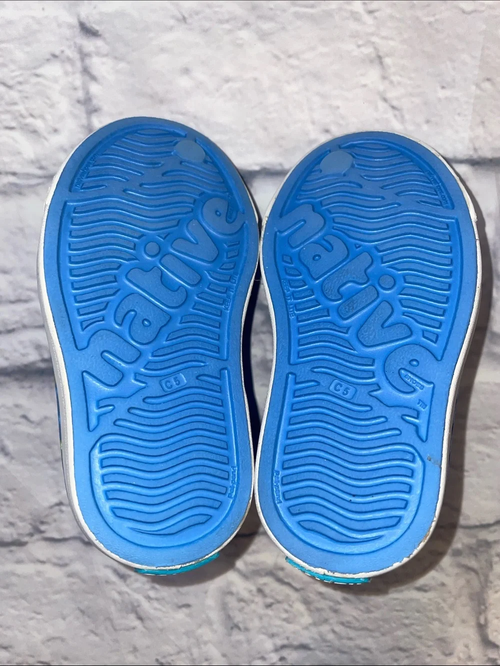 Native Jefferson Blue Slip-On with Neon Lightning Bolts. Size 5